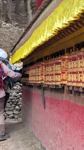 Hikers spin prayer wheels, trek through Khumjung village Nepal