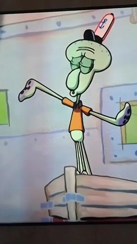 A cartoon squid character named Squidward Tentacles is singing and gesturing dramatically while standing on a boat. He is wearing a sailor's hat and an orange shirt. The background appears to be a room with light blue walls.