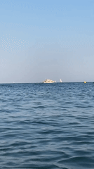 Calm afternoon on the Costa Brava coast with boats and breakwater