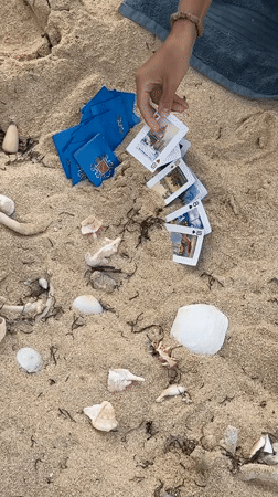 Person plays cards on beach in Santa Monica, Philippines