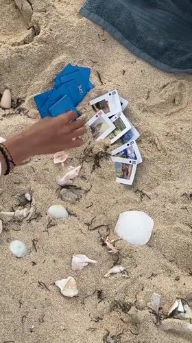 Person plays cards on beach in Santa Monica, Philippines