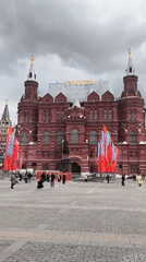 Tourist documents Red Square landmarks under cloudy Moscow skies