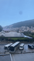 Rain rolls through Budva, life carries on around it