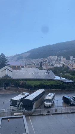 Rain rolls through Budva, life carries on around it