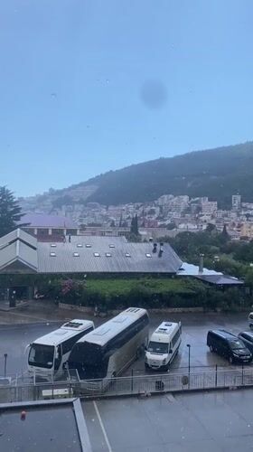 Rain rolls through Budva, life carries on around it