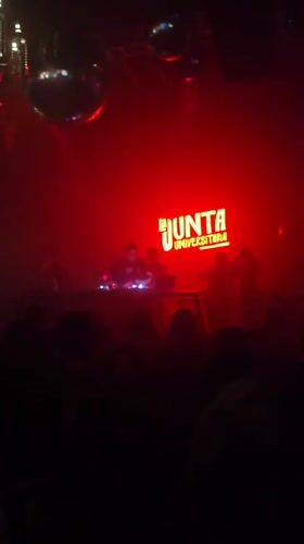 Late-night club scene in Iquique with DJ and neon lights