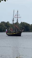 Tall ship sails past as lawn games unfold at outdoor event