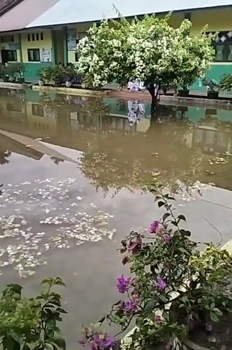 School courtyard flooded in Pulosiron, Indonesia