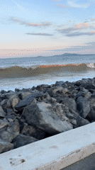 Sunset captured along Burgas coastline with crashing waves