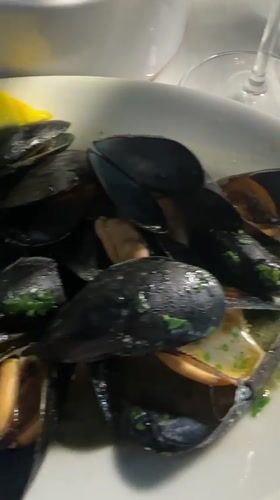 Mussels and a burger at a Milan restaurant