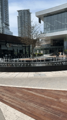 Urban plaza with fountain observed in Burnaby evening