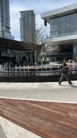 Urban plaza with fountain observed in Burnaby evening