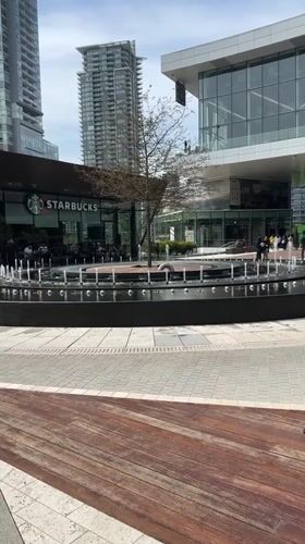 Urban plaza with fountain observed in Burnaby evening