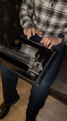 Person uses vintage typewriter on couch in Bogota