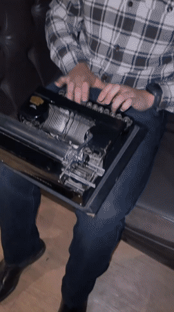 Person uses vintage typewriter on couch in Bogota