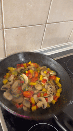 Home cook prepares vegetable sauté with halloumi in Budapest