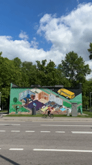 Colorful house mural with school bus documented in Moscow