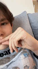Person rests thoughtfully on couch in Dnipro