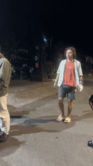 Man in casual attire walks North Kuta street
