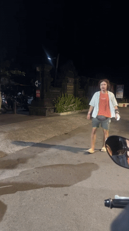 Man in casual attire walks North Kuta street