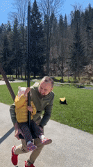 Adult helps child at playground in Wisła, Poland