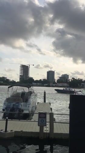 White boat docked at Ikoyi harbor amid construction activity