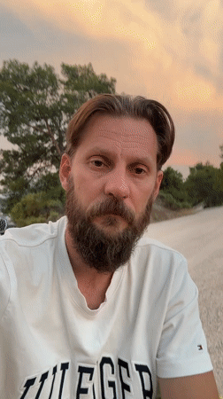 Man enjoys drink outdoors during sunset in Fethiye, Turkey