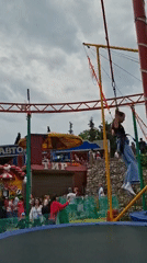 Families enjoy carnival games and waterfront activities at amusement park