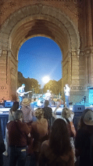 Live band performs at dusk in front of Arc de Triomf
