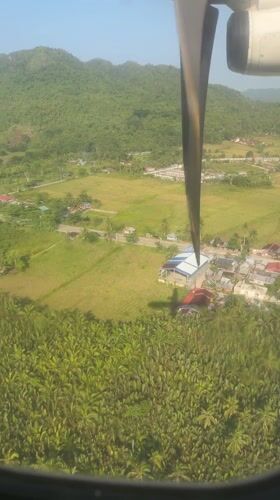 Aerial view captured over Del Carmen, Philippines from small aircraft