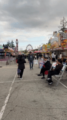 Outdoor carnival operates rides in Coquitlam under cloudy skies