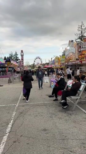 Outdoor carnival operates rides in Coquitlam under cloudy skies