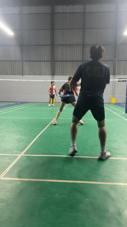 Doubles badminton match at an indoor court in Ko Samui