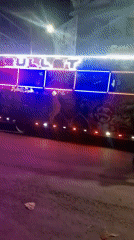 Pedestrian walks past decorated bus in Nairobi street