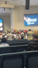 Church gathering in Surrey with international flags and stage group