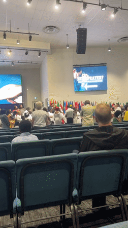 Church gathering in Surrey with international flags and stage group