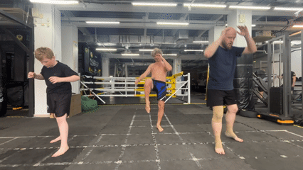 Three men perform martial arts routine at Perm gym