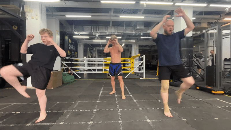 Three men perform martial arts routine at Perm gym