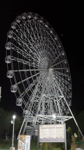 Evening stroll captures illuminated Ferris wheel in Serbian spa town