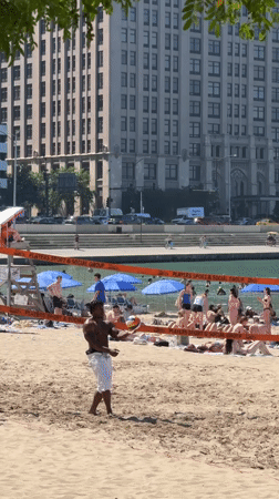 Beach volleyball in action on a busy Chicago shoreline