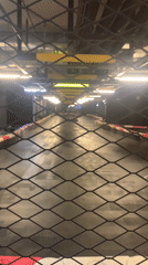 Inside a racing-themed go-kart venue with active track
