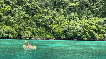 Boats and kayaks on the turquoise waters off Ao Nang