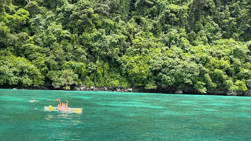 Boats and kayaks on the turquoise waters off Ao Nang