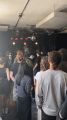 Live band set at a dimly lit indoor venue