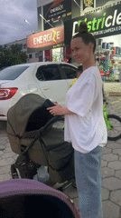 Woman with baby stroller observed on Florianópolis sidewalk