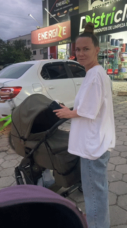 Woman with baby stroller observed on Florianópolis sidewalk