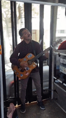 Street musician performs aboard Buenos Aires public transport vehicle
