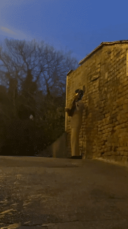 Street musician performs guitar on wet Zagreb alleyway