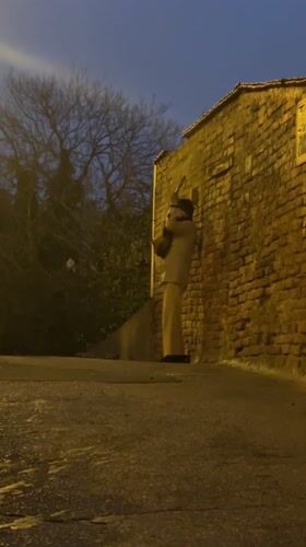 Street musician performs guitar on wet Zagreb alleyway