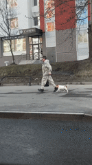 Man walks Jack Russell amid cloudy skies in Moscow